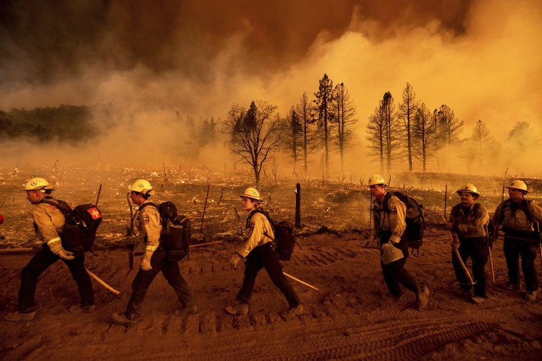 Thousands of firefighters battle wildfires burning more than 850,000 acres across 12 states